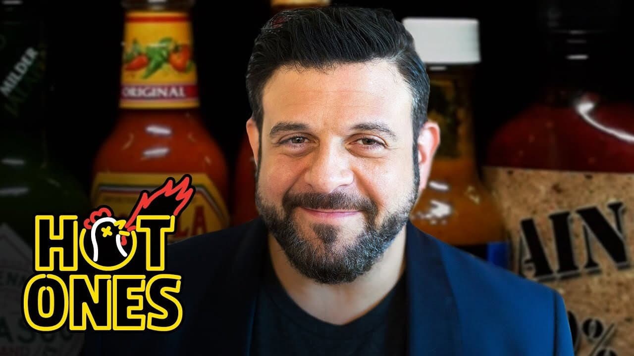 Still from Adam Richman Impersonates Noel Gallagher While Eating Spicy Wings