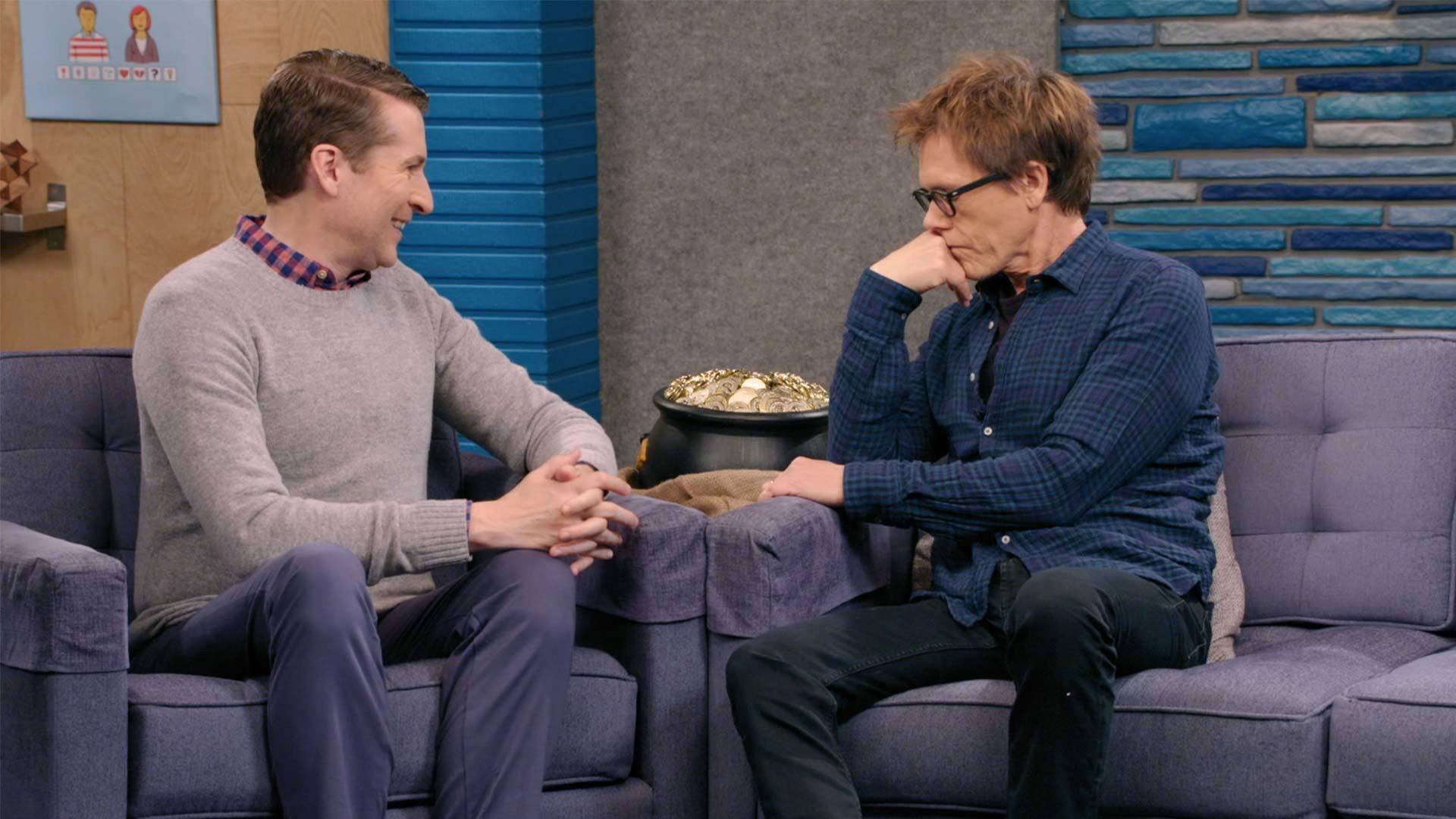 Still from Kevin Bacon Wears a Blue Button Down Shirt and Brown Boots