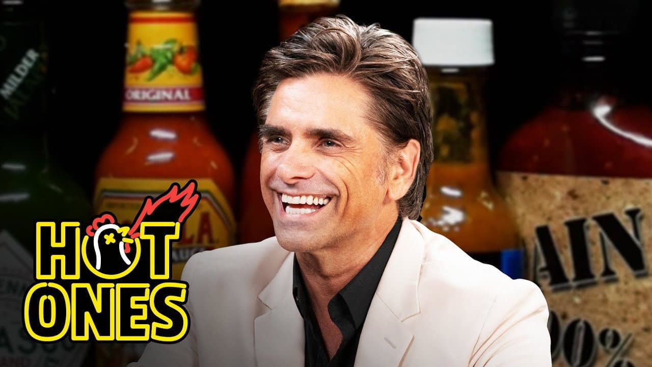 Still from John Stamos Falls Out of His Chair While Eating Spicy Wings