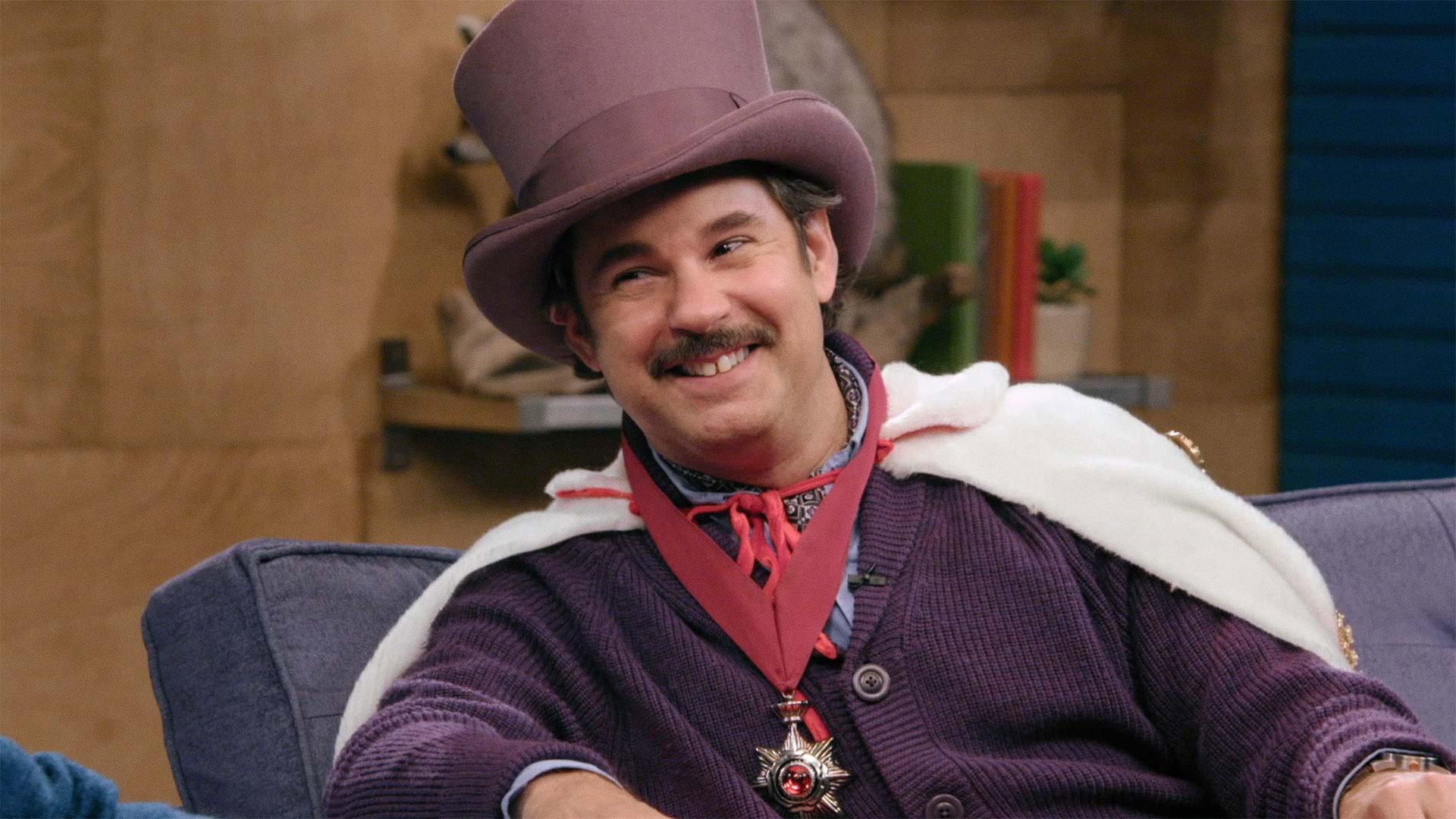 Still from Lord Andrew Lloyd Webber Wears a Purple Top Hat & Fabrice Fabrice Wears One Pink Fur Leg Warmer