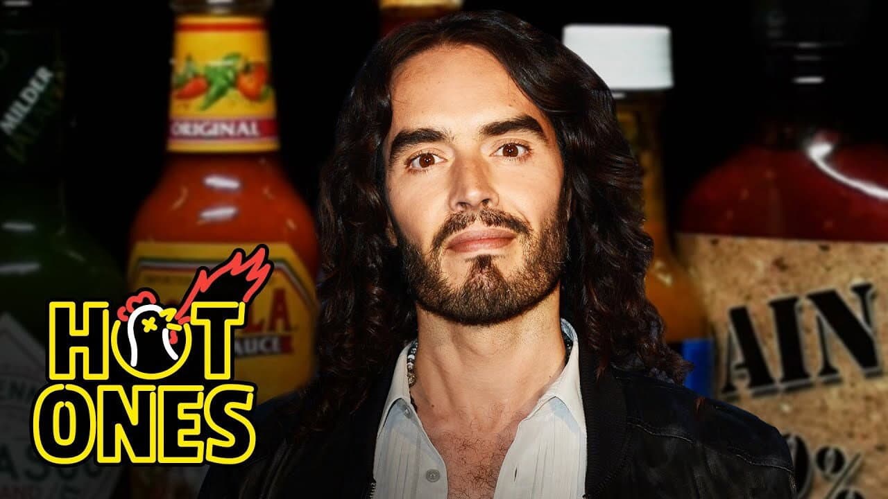 Still from Russell Brand Serenades Superfan Brett Baker While Eating Spicy Wings